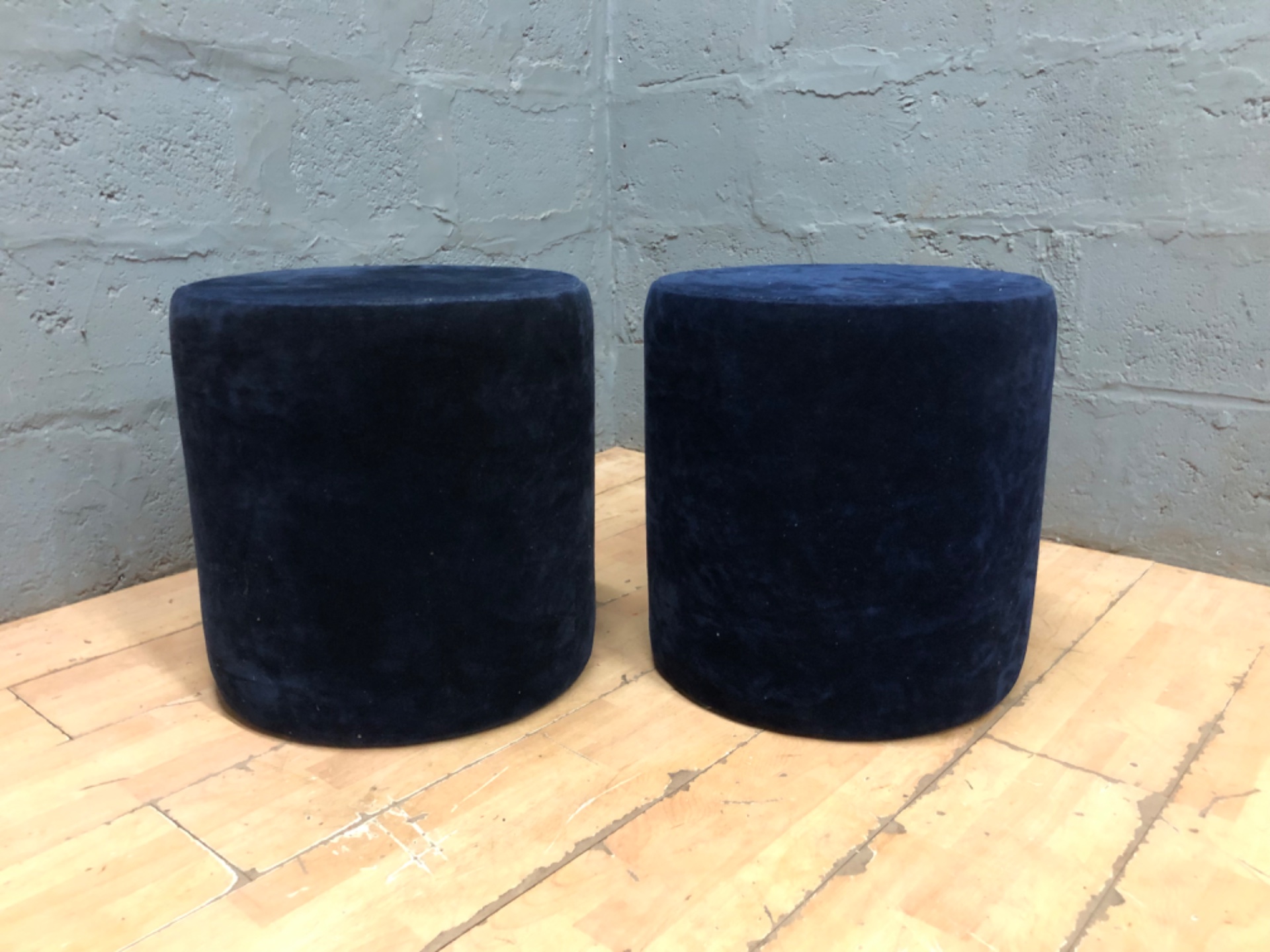 Pair of navy velvet cylindrical pouffe stools — 50 H x 48 Ø cm (each) — used, stained