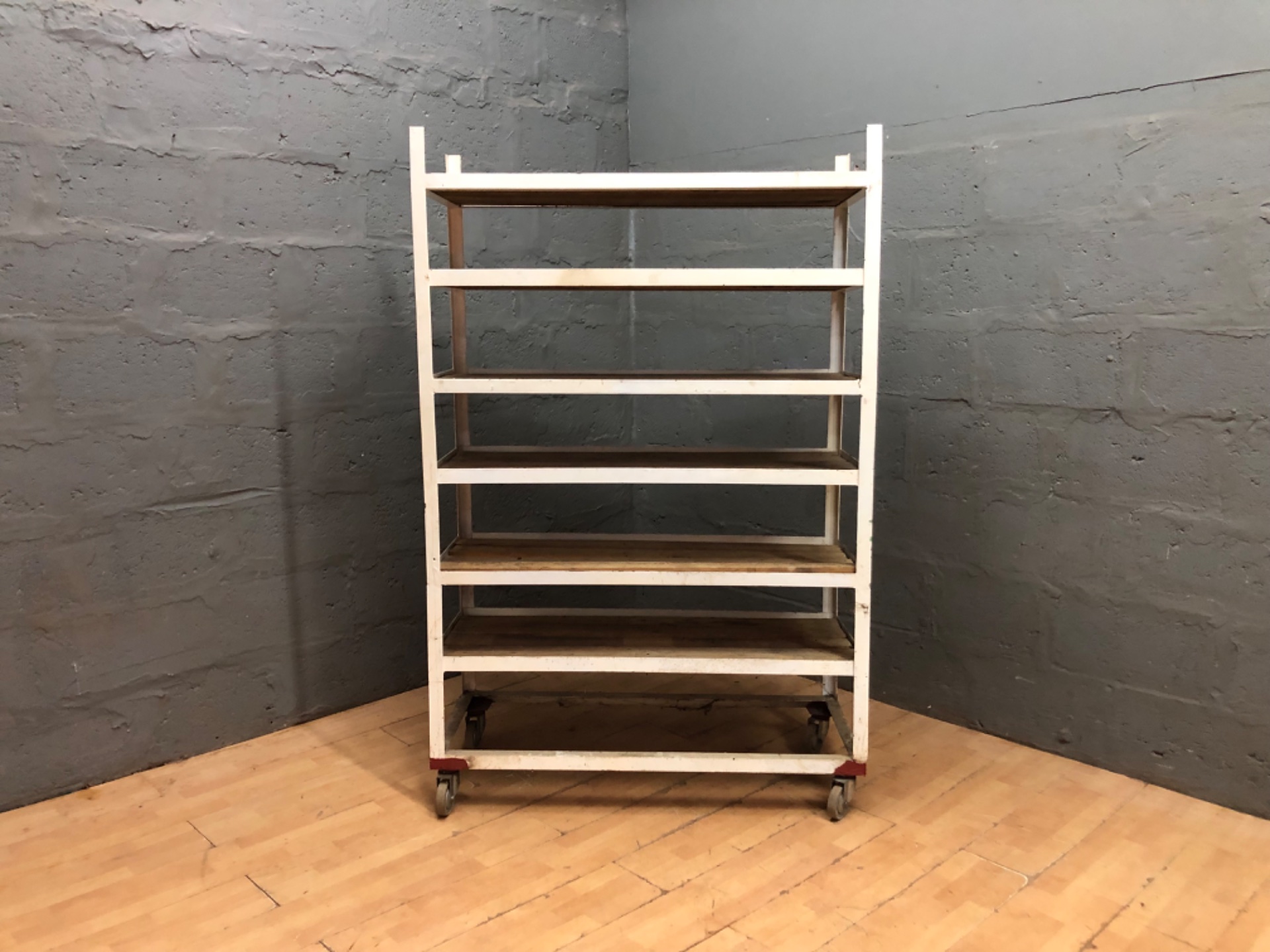 Wheeled industrial shelving unit – painted metal frame with wooden slatted shelves