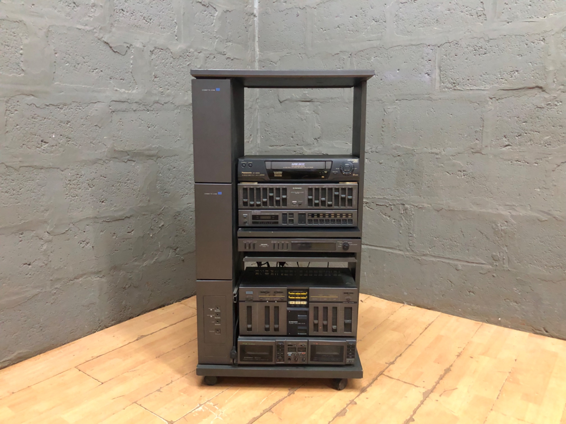 Vintage stacked hi‑fi system in tall cabinet – Panasonic NV‑HD625 VHS + Pioneer components (untested)