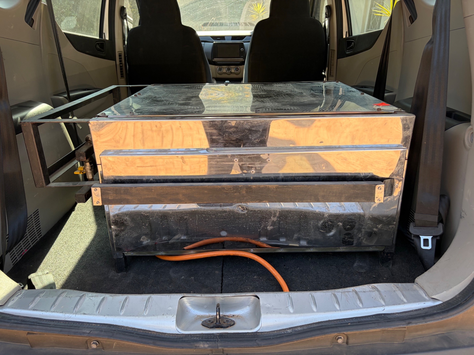 Large stainless-steel gas pizza oven — commercial unit with visible burner tubes and orange LPG hose (sold as is, untested)