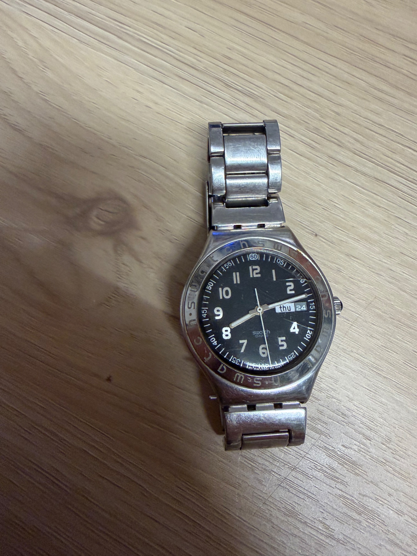 Swatch stainless-steel wristwatch — black dial, day/date display, worn condition (untested)