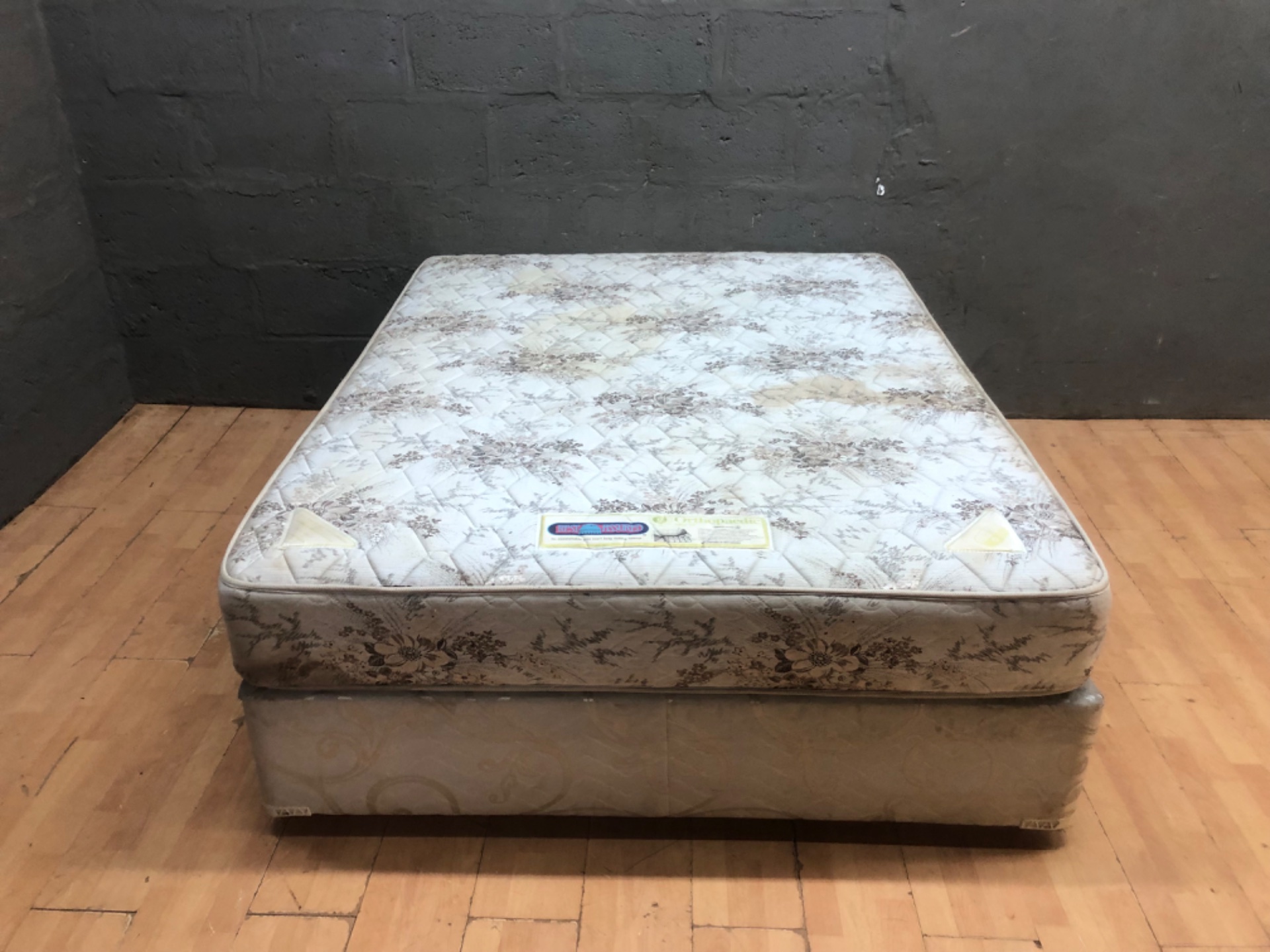 Rest Assured Orthopaedic MQ10 — Queen mattress with matching divan base (used, stained)