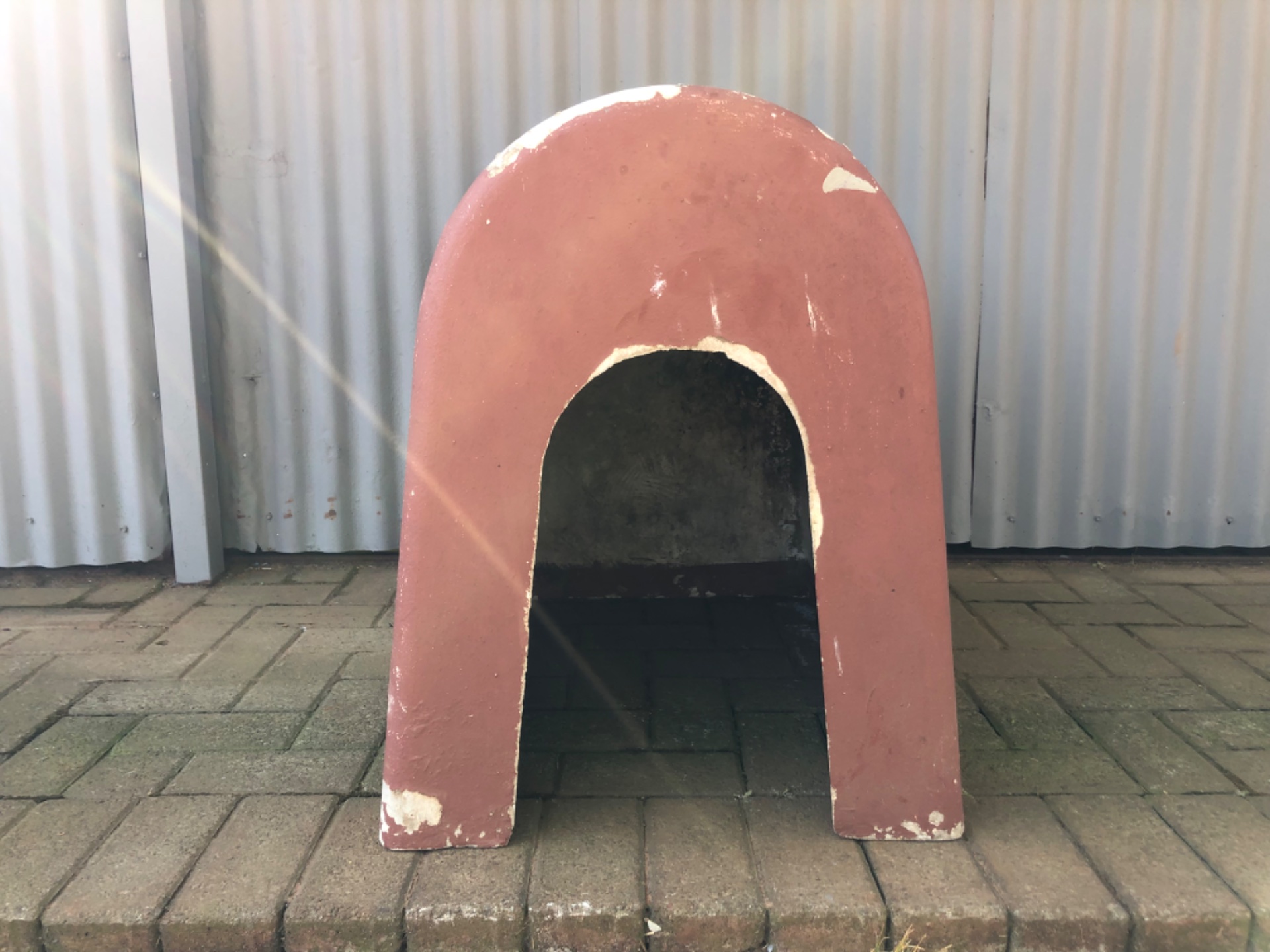 Single-piece concrete outdoor dog kennel / pet house — 68 x 70 x 47 cm — paint peeling, interior soiled