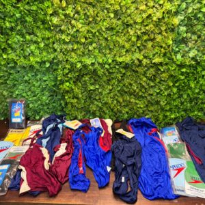 Bulk lot of mixed one‑piece swimsuits with Speedo swim caps (mixed new & used)