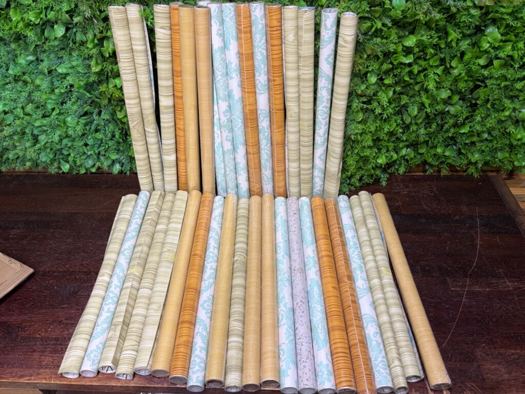 Bulk lot — Approx 35 rolls contact-adhesive wallpaper / contact paper (assorted woodgrain & damask)