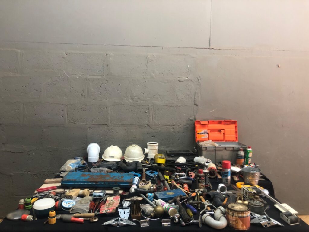 Mixed hand tools, plumbing fittings, hoses, hard hats & small parts — assorted used lot