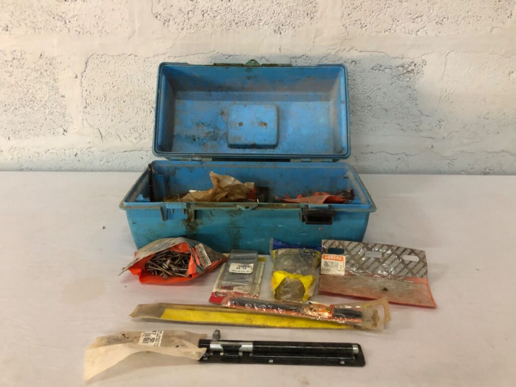 Used blue plastic toolbox with assorted drill bits, screws and packaged fixings (Eureka, Abracon visible)