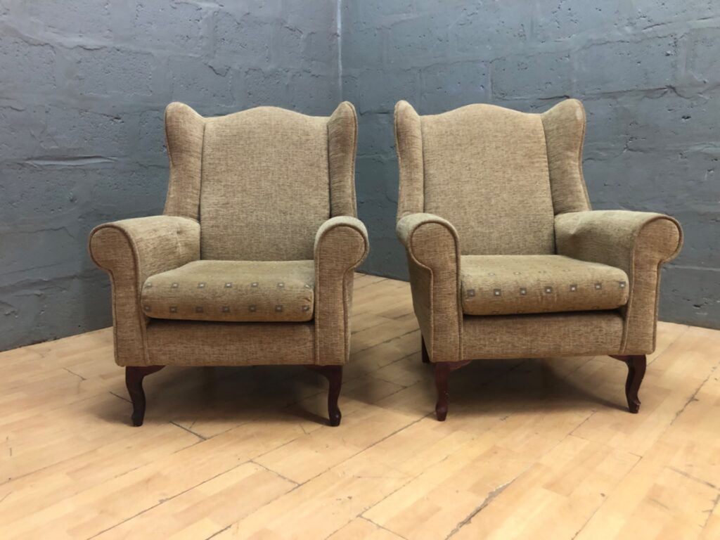 Pair of wingback armchairs – beige patterned upholstery with wooden cabriole legs