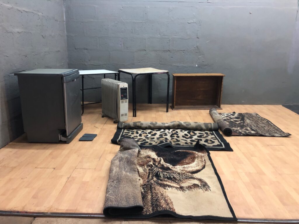 Mixed household lot – freestanding dishwasher (hoses included), Tropical oil heater, 3 small metal tables, wooden shelf/box and assorted rugs
