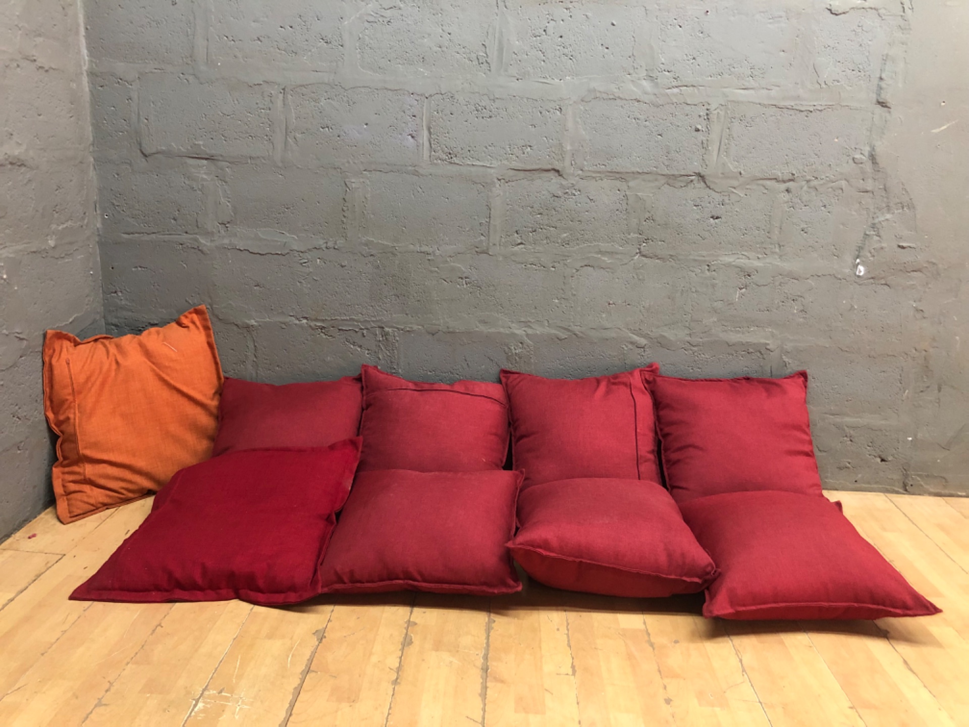 Set of 9 Red Floor / Scatter Cushions (one orange) — removable zip covers, polyester filling