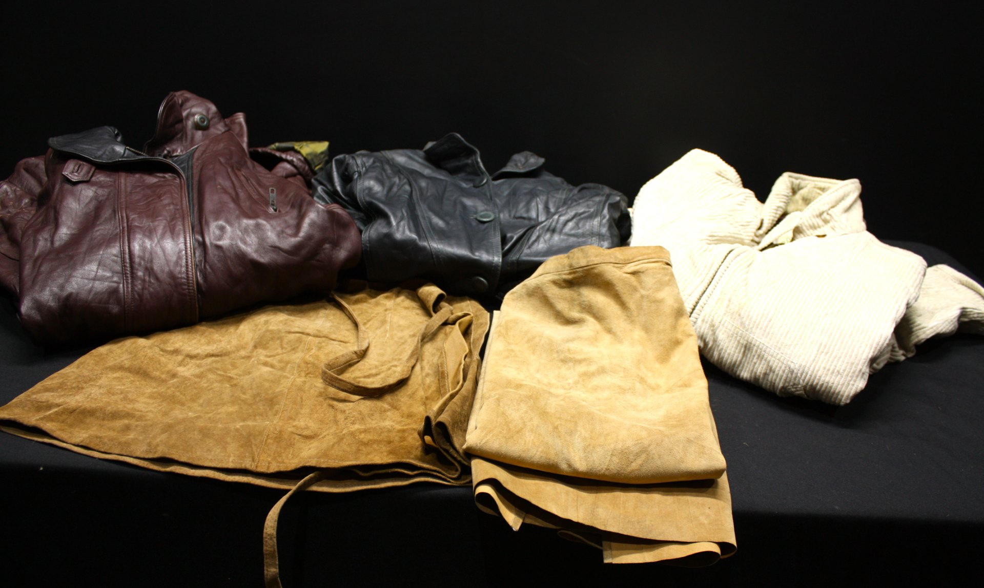 Mixed lot of used outerwear — leather, suede and corduroy jackets (one St. John’s Bay visible)