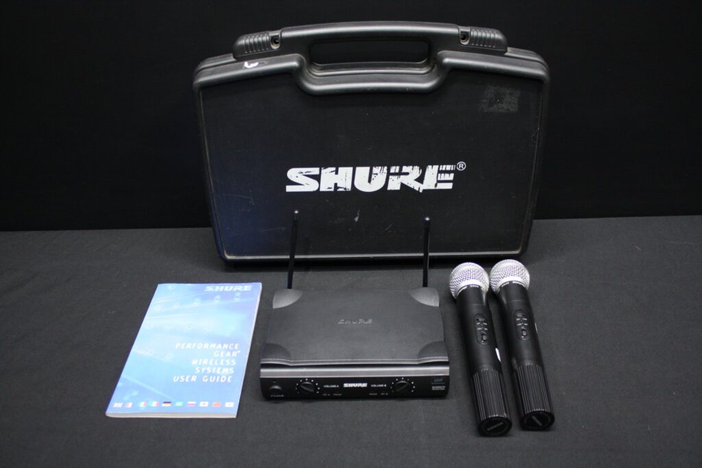 Shure UHF wireless set with 2 handhelds (SM58-marked heads), receiver, case, manual — powers on, sold as-is (untested)