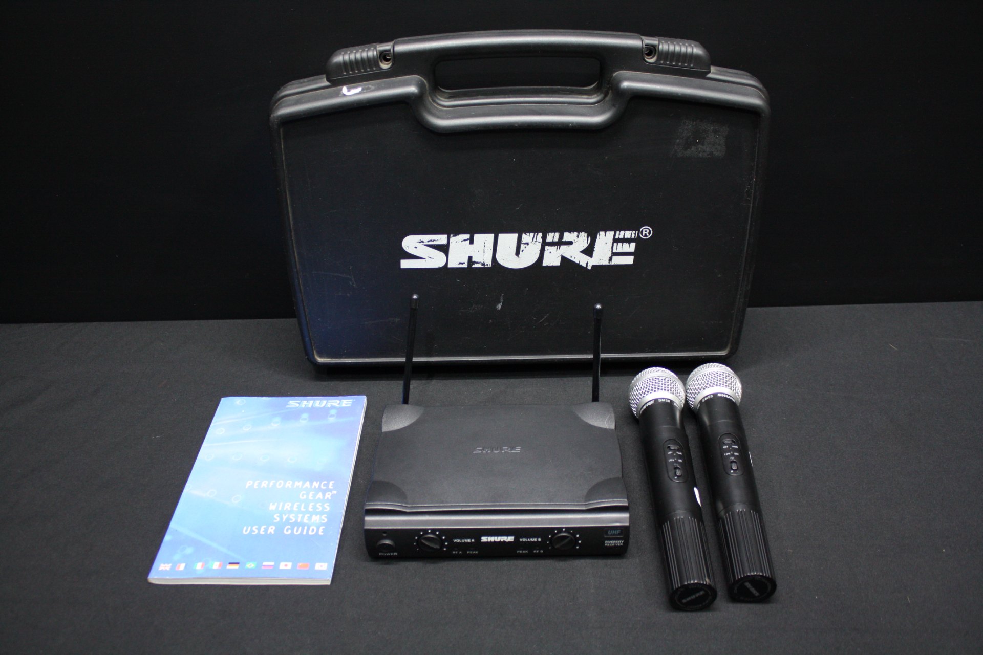 Shure UHF wireless set with 2 handhelds (SM58-marked heads), receiver, case, manual — powers on, sold as-is (untested)