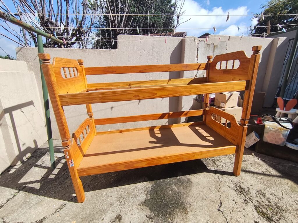 Wooden children’s bunk bed with two under‑bed rolling boxes — used, complete set