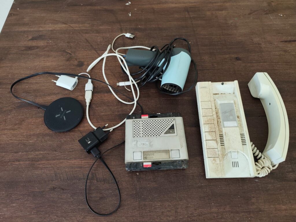 Assorted small electronics lot — ROMOSS wireless pad, assorted chargers, handset & answering unit (Heavily used / worked last time)