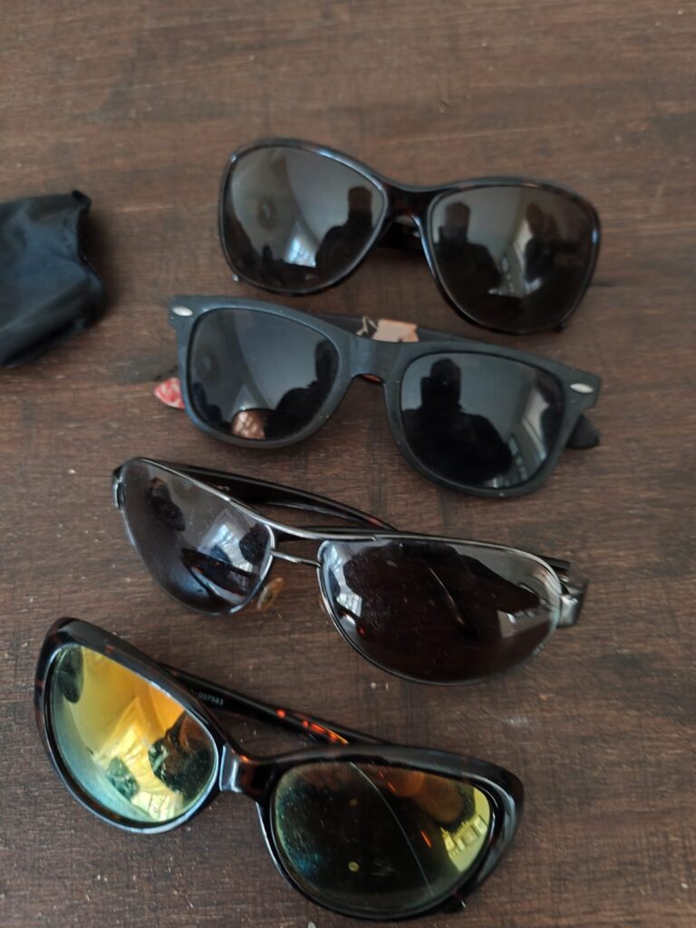 Lot of 4 used sunglasses with 2 protective cases — mixed styles, fair condition (scratches & scuffs)