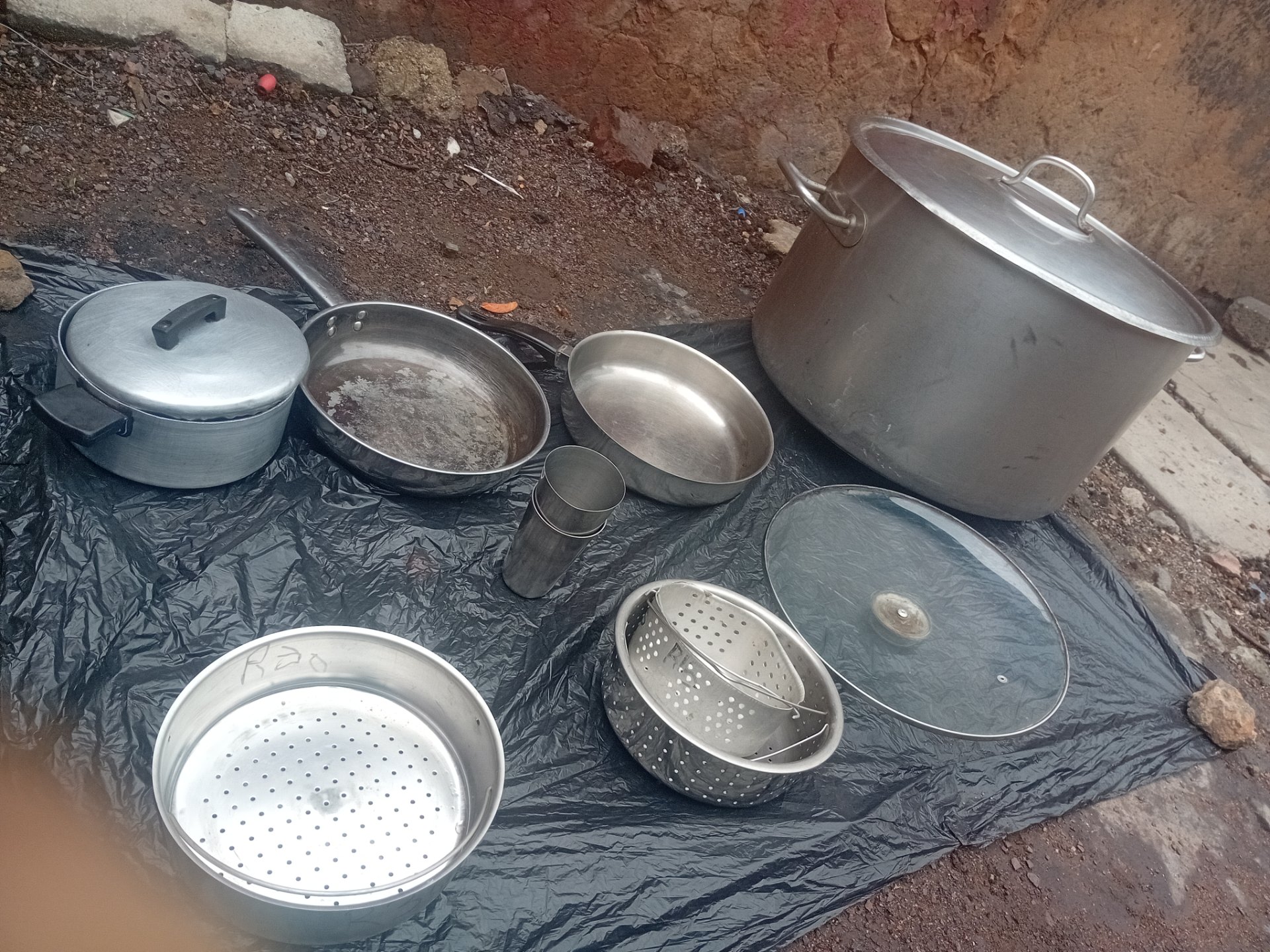 Large stainless stockpot (≈50cm) + mixed cookware lot — heavy wear, welded repairs, leaks
