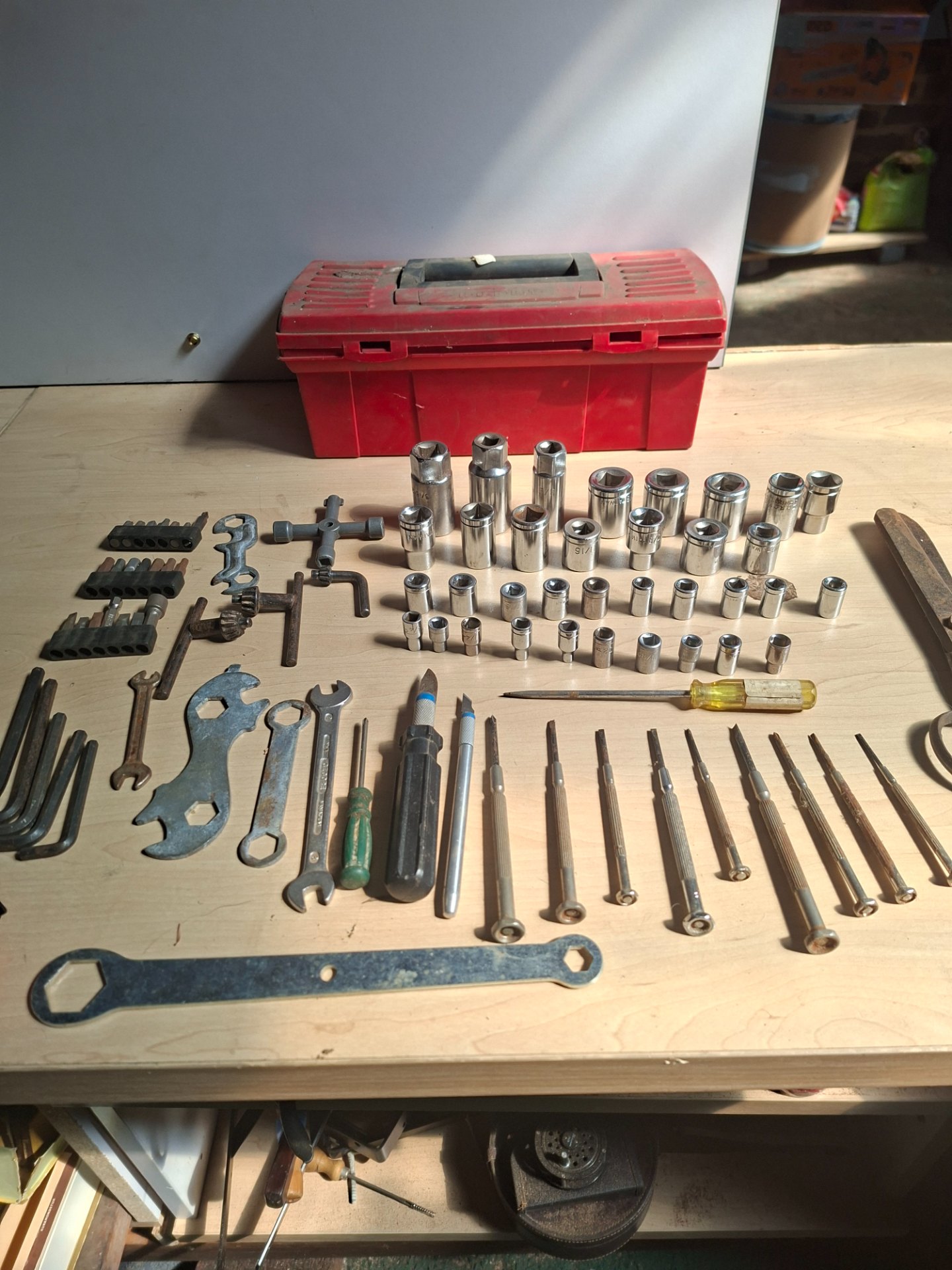 Assorted small hand tools & socket set with red toolbox — mixed sockets, bits, drivers, scissors (used, rusted)