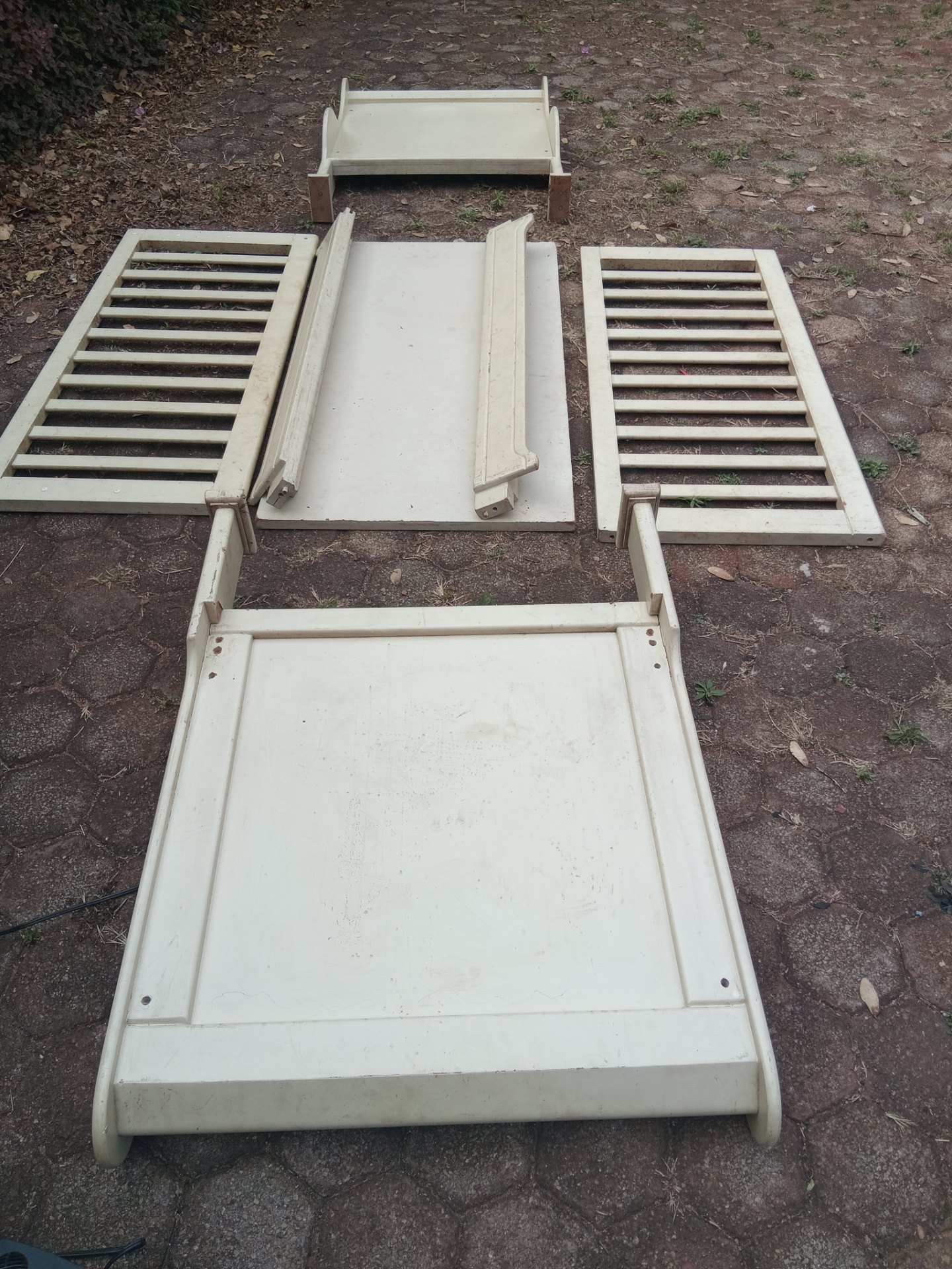 Disassembled cream-painted kids cot / bed frame (MDF) — headboard, footboard, side rails & slatted base — needs bolts & nuts