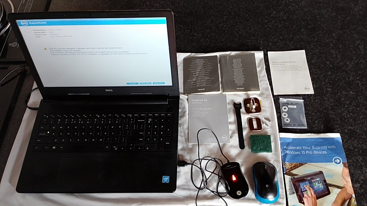 Dell Inspiron 15 (Inspiron 15-3552) laptop — boots to BIOS & Windows setup, charger & accessories