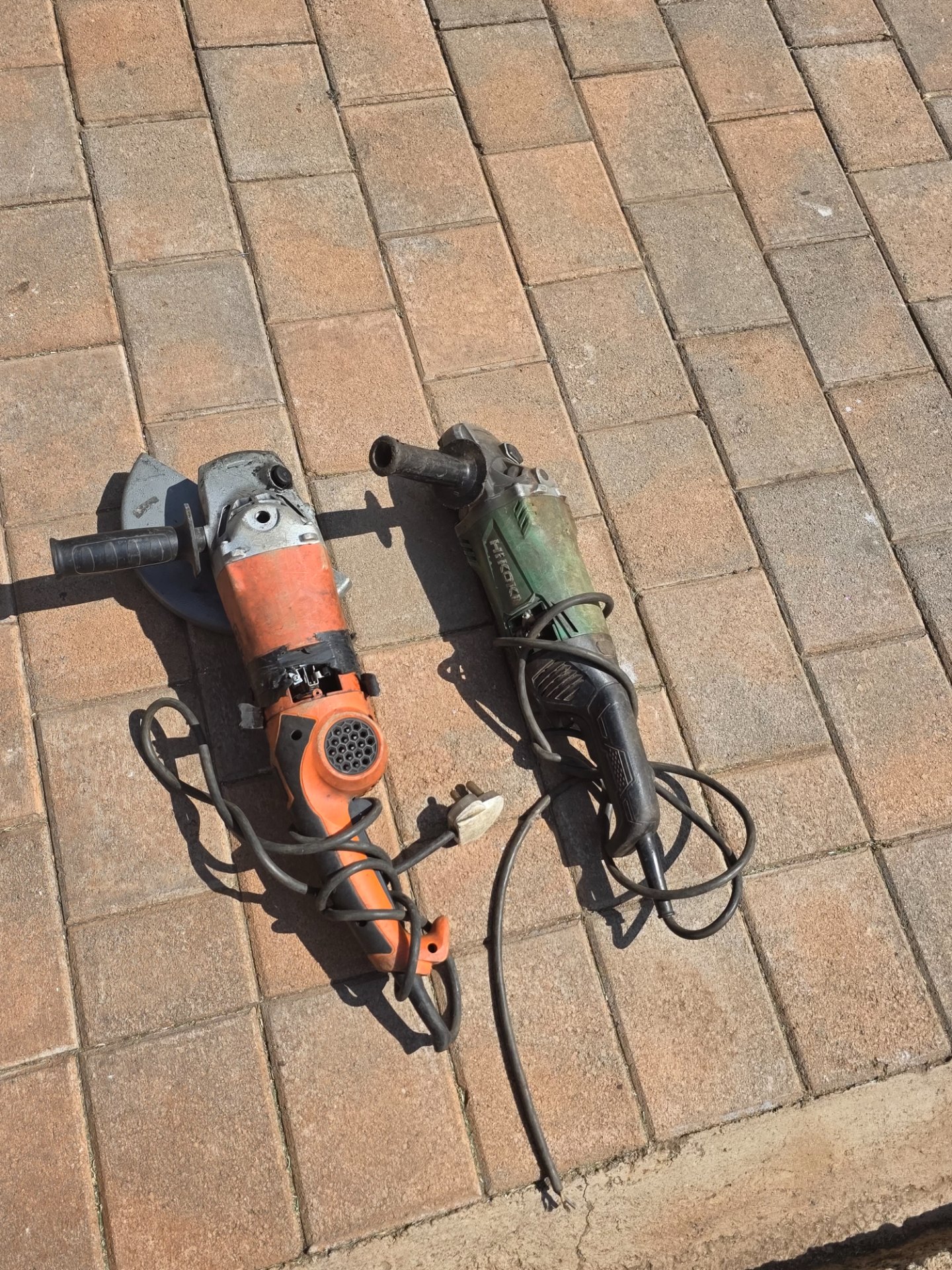 Lot of 2 corded angle grinders — one marked Hikoki — for spares/repairs