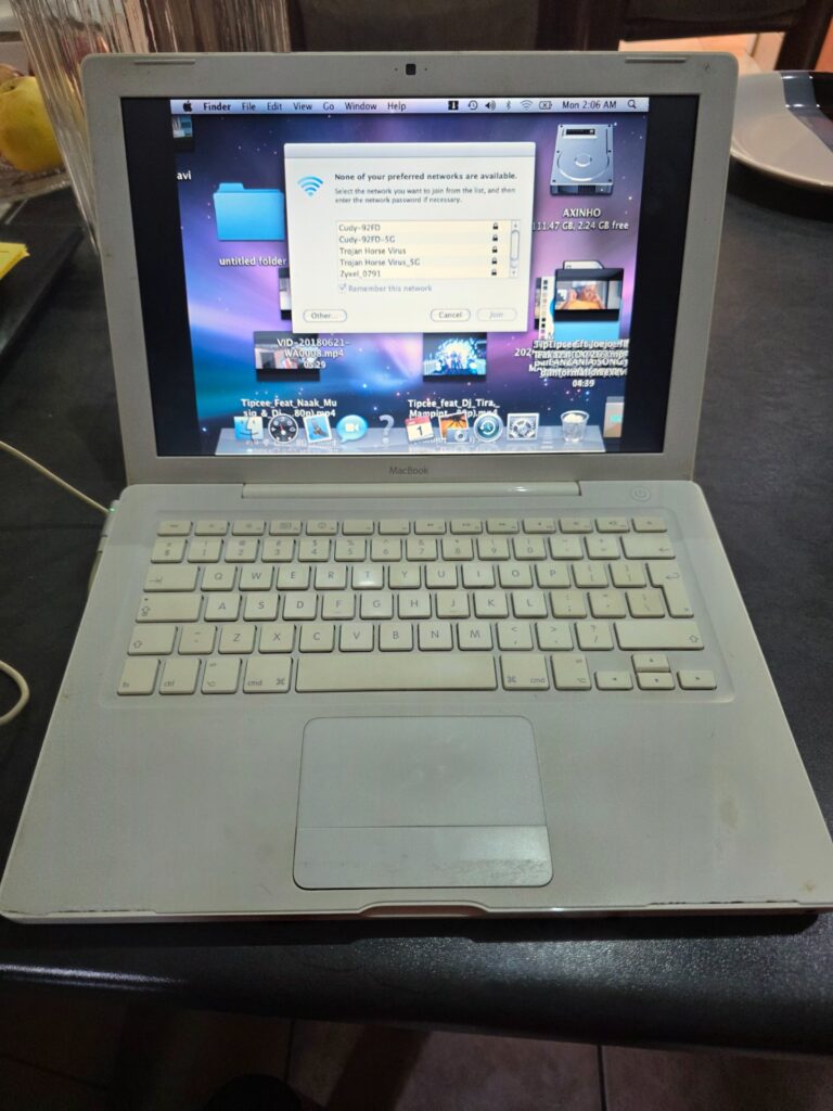 Apple MacBook (white polycarbonate) — boots to macOS, MagSafe charger included, battery does not hold charge