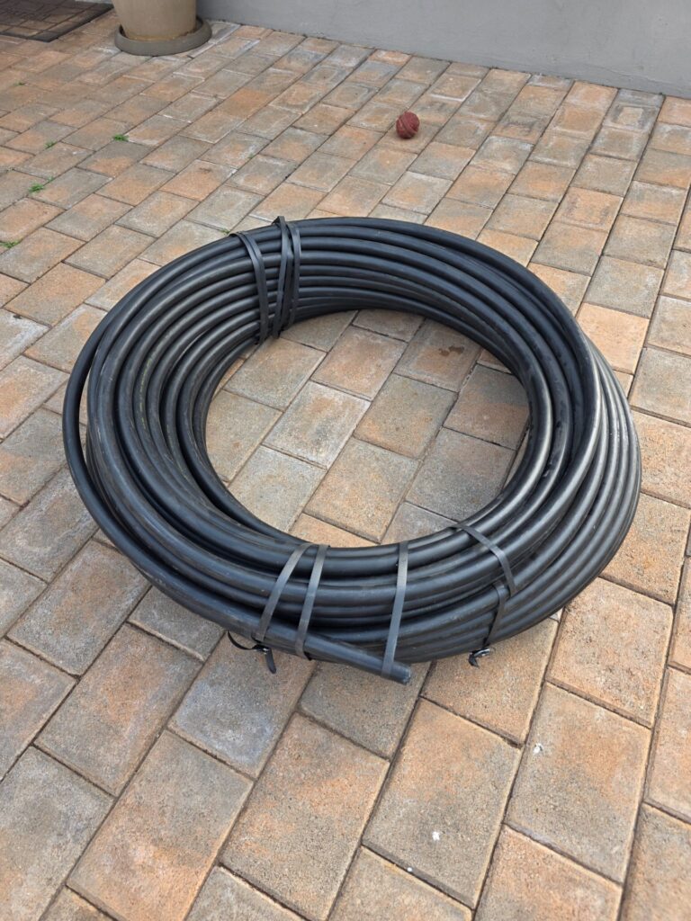 Coil of black HDPE irrigation pipe (seller: brand new)