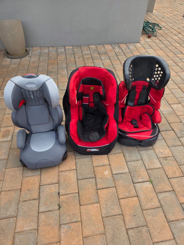 Lot of 3 used child car seats — Graco (grey) + Scuderia Ferrari (red) + red booster-style — used, harnesses present