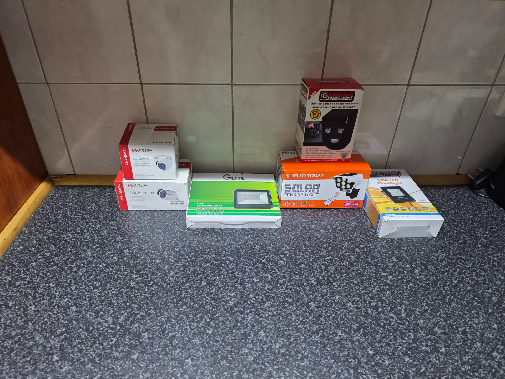 Mixed lot: 6x boxed outdoor/security lights + Hikvision Turbo HD CCTV cameras — brand new sealed (boxes creased)