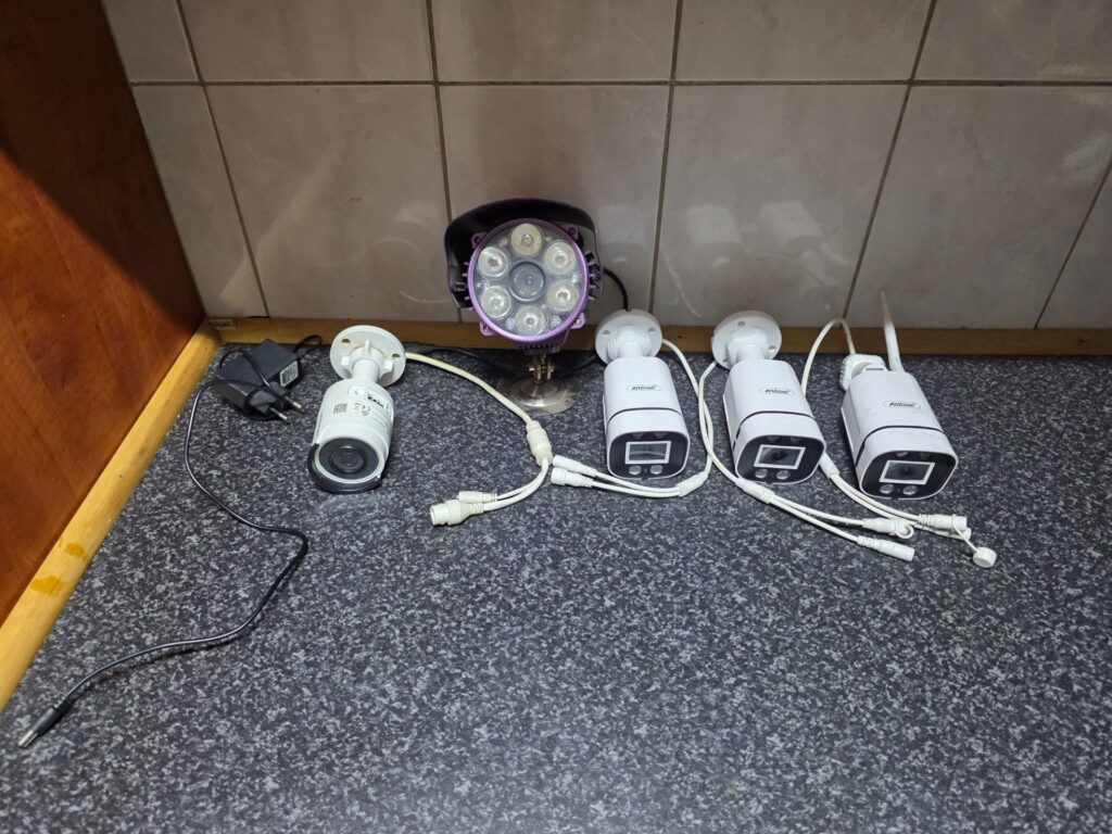 Assorted CCTV camera lot – 3x Andowl bullet, 1x Hikvision, 1x purple IR camera housing – tested working