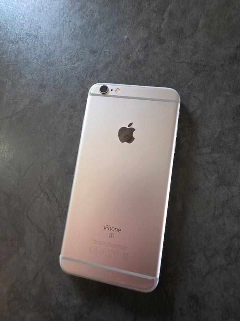 Apple iPhone (rear marked ‘s’ — likely 6s) Space Grey — screen intact, rear scuffs & crushed lower corner, reset but needs iTunes