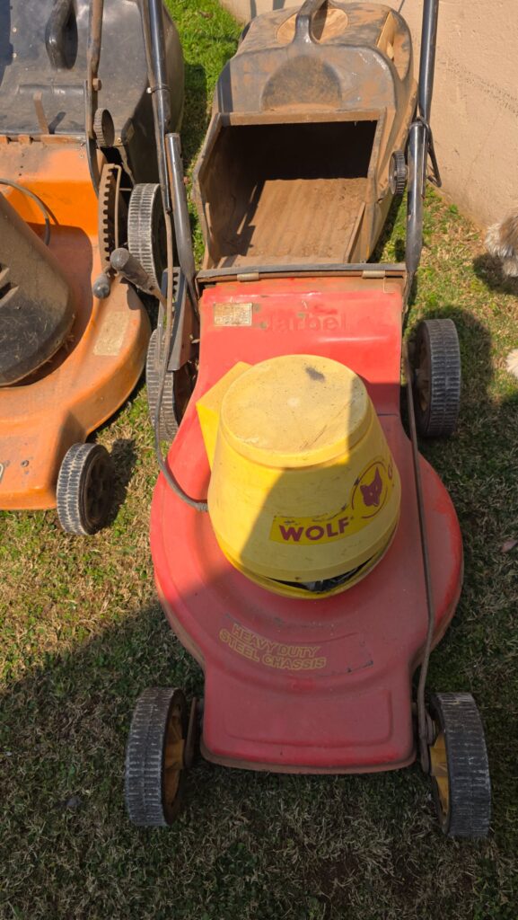 Lot of 2 corded push lawn mowers — WOLF red unit + orange unit (used, untested)