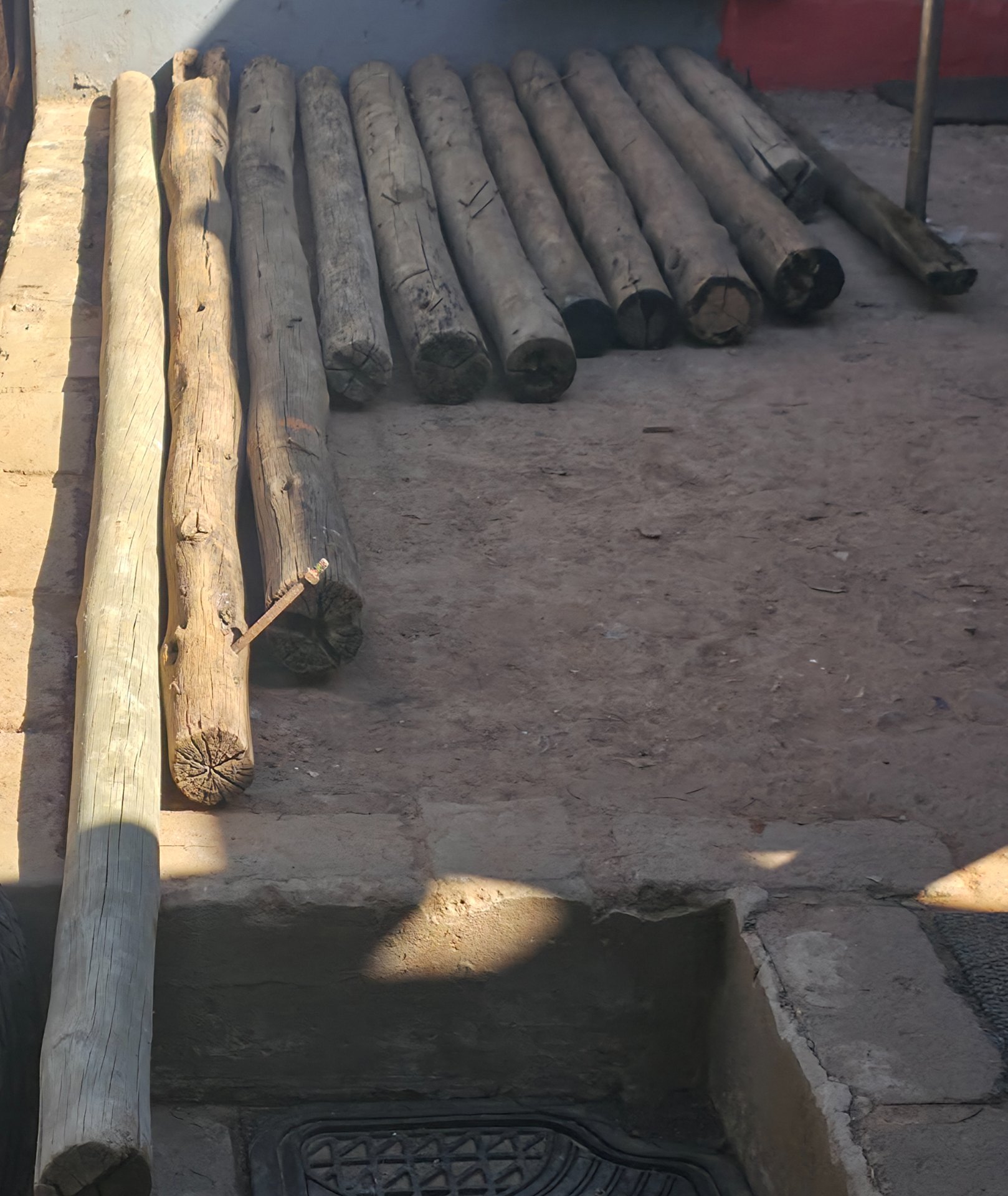 Lot of 12 Round Wooden Poles / Logs — Various Sizes, Some Treated — Weathered with Splits & Nails
