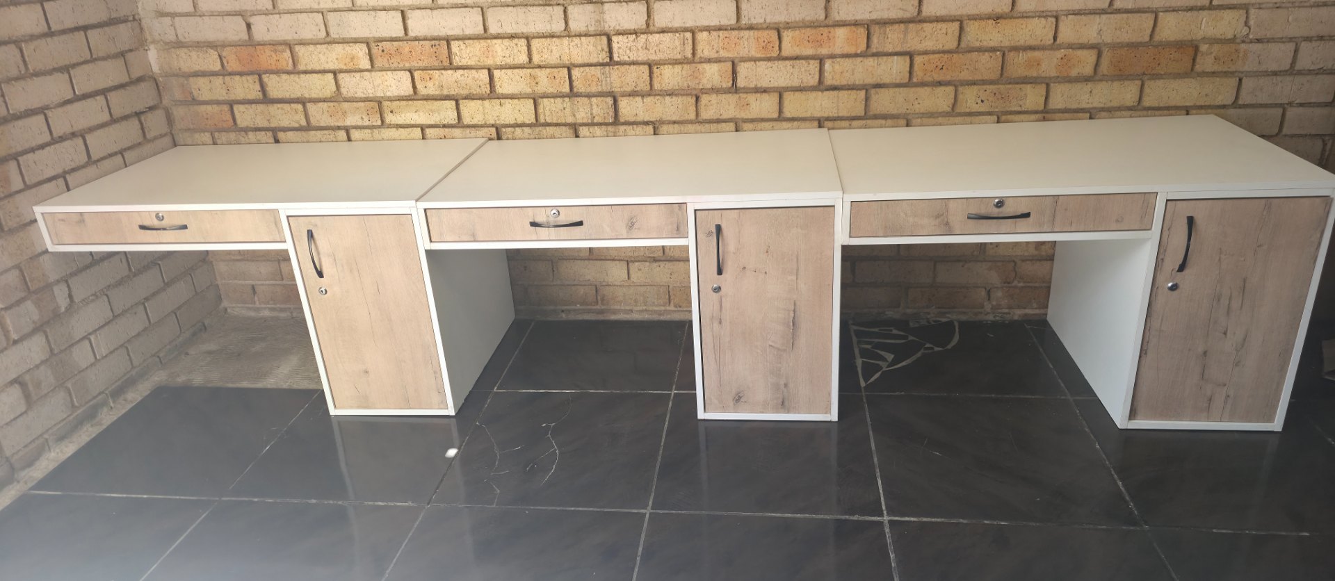 Three-module office desk / bench — white tops with wood-effect drawer & cupboard fronts