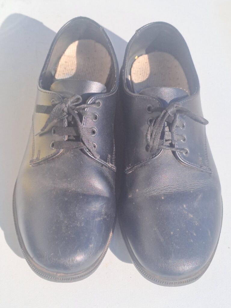 Toughees black school shoes — child size 5, preowned pair with scuffs
