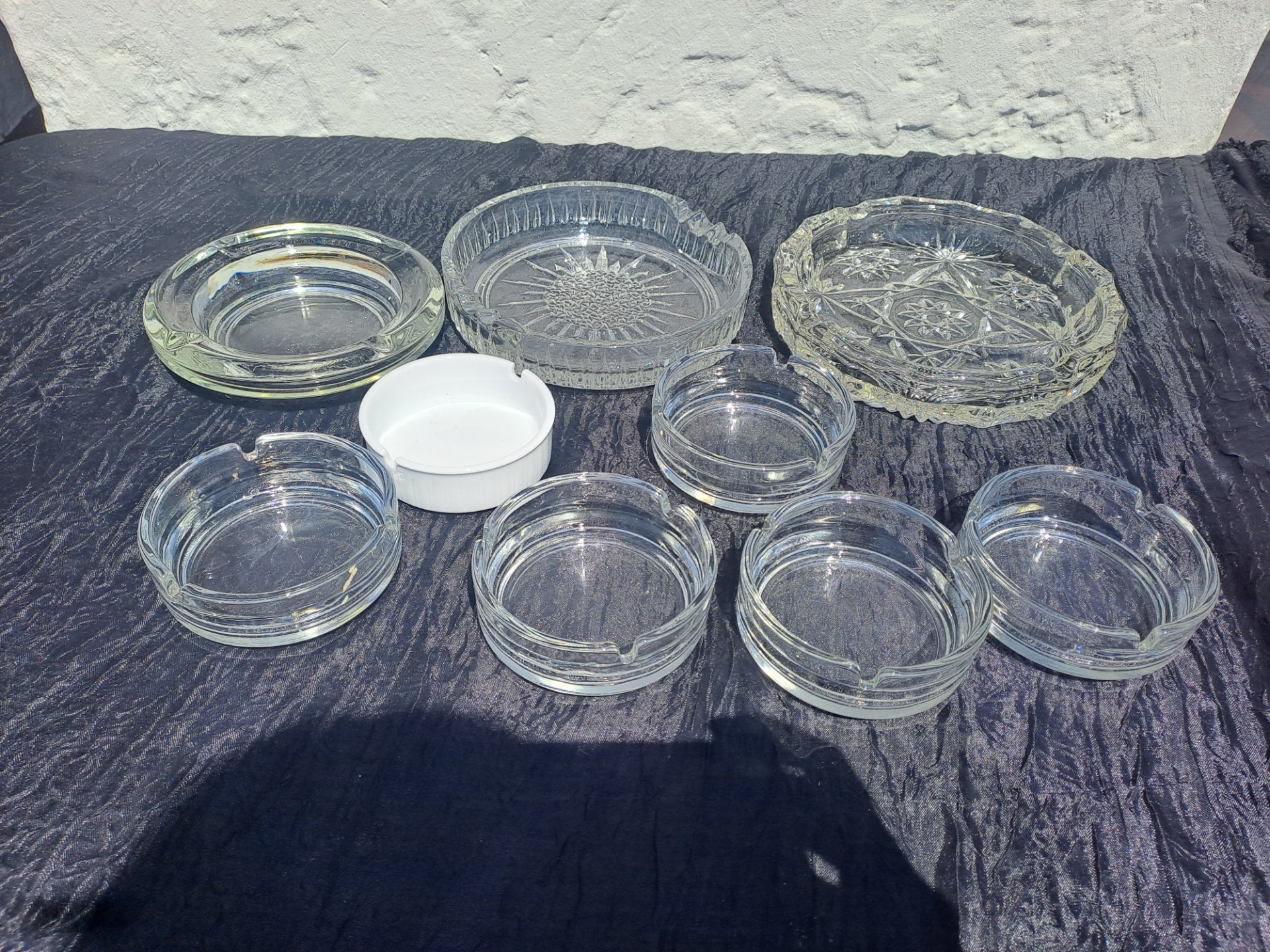 Assorted Clear Glass Ashtrays + White Ceramic Dish — Mixed lot, mostly intact, surface wear