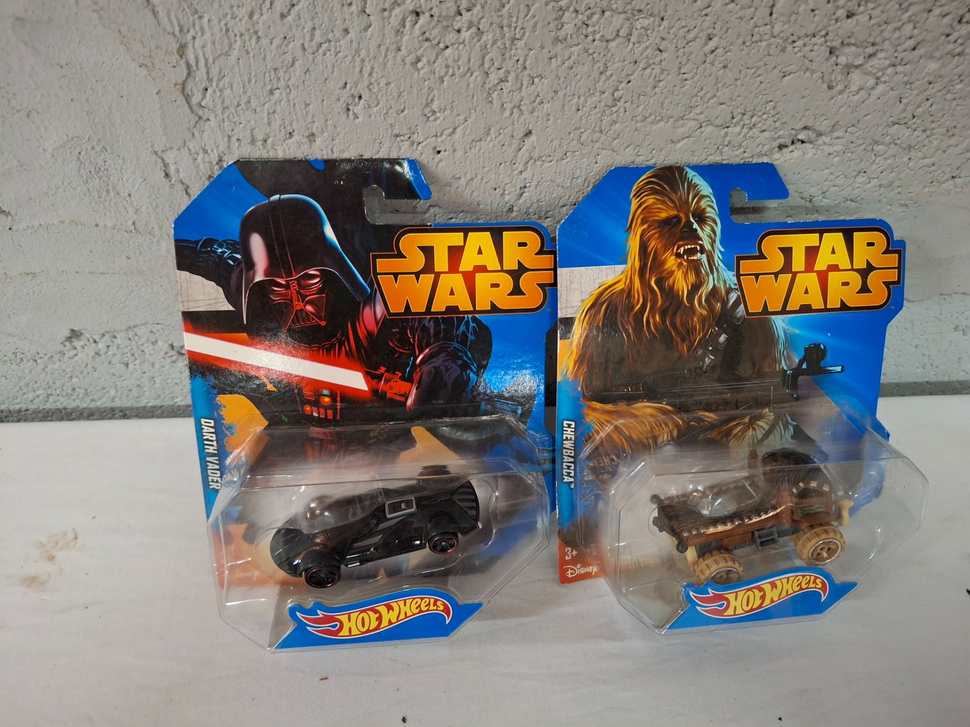 Hot Wheels Star Wars — Darth Vader & Chewbacca die-cast cars (carded, visible packaging wear)