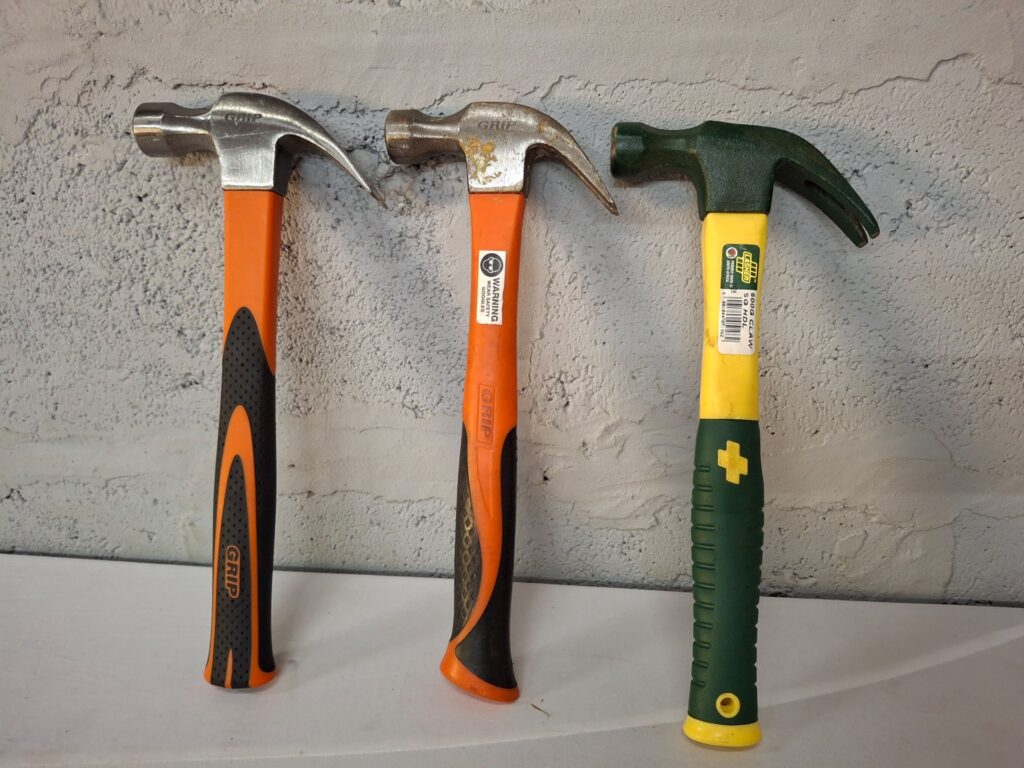 Lot of 3 Claw Hammers — assorted GRIP-stamped heads, rubber/grip handles, used
