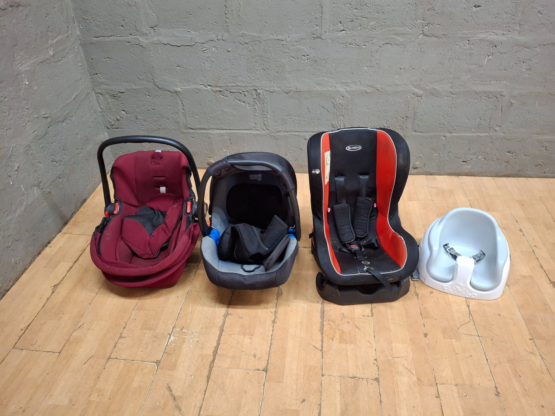 Mixed lot: 4 baby seats — 2 infant carriers, 1 Bambino convertible car seat & 1 Bumbo-style floor seat (used, heavy wear)