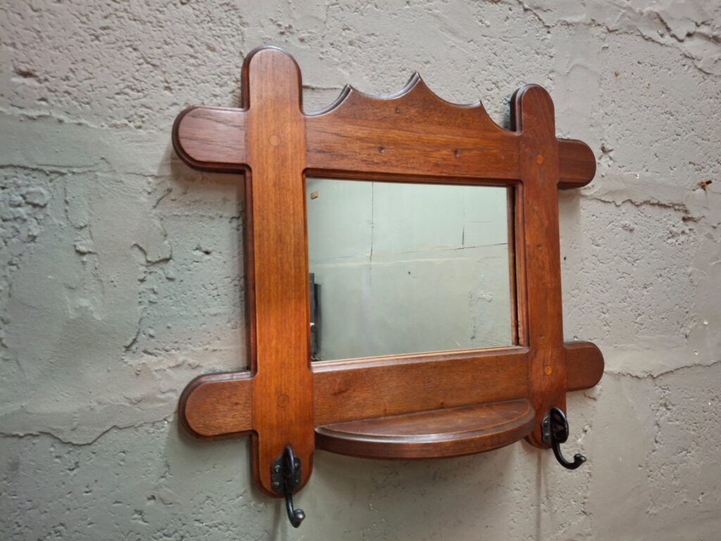Vintage oak wall mirror with curved shelf and two metal hooks