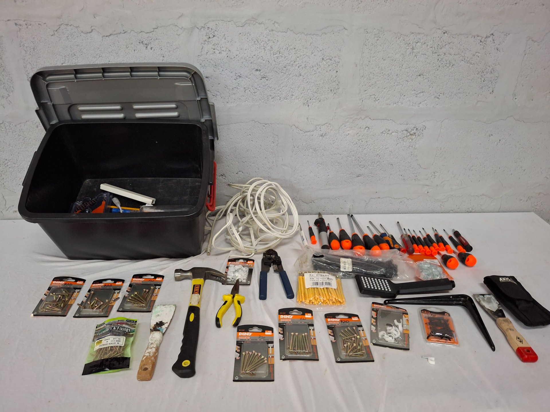 Mixed hand tools & fixings bulk lot — screwdrivers, pliers, hammer, crimper, sealed screws & zip-ties + plastic tub