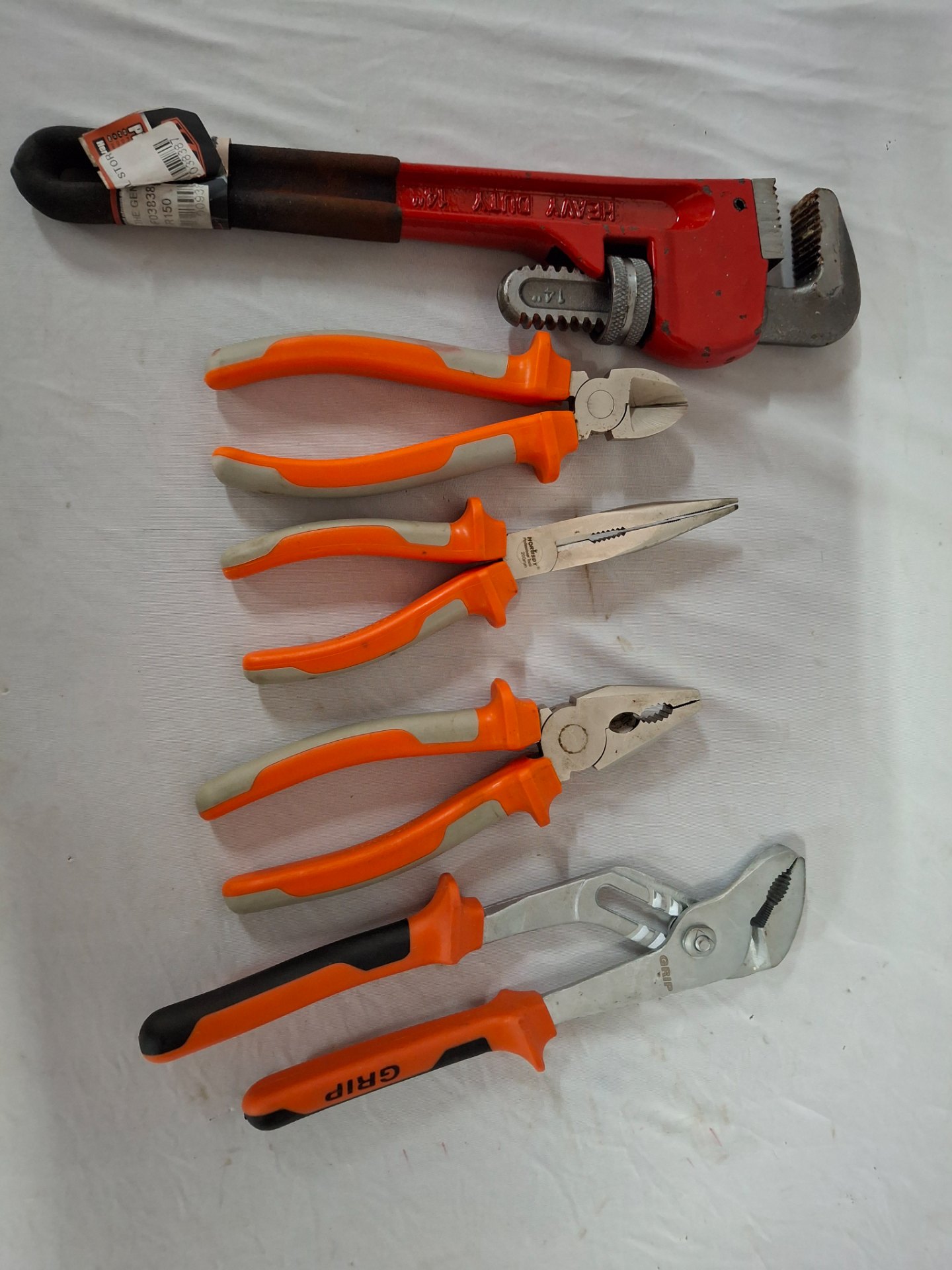 Lot: Assorted hand pliers + heavy-duty 14″ pipe wrench — 5-piece used set (VDE-marked handles, light rust / paint chips)