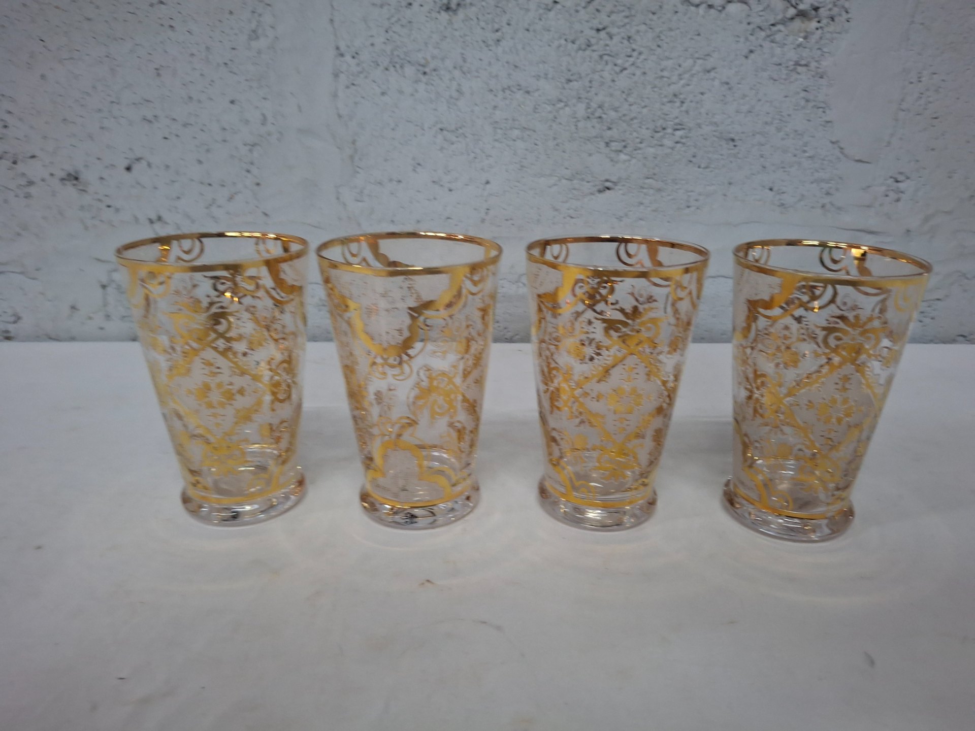 Set of 4 clear glass tumblers with gold gilt decoration