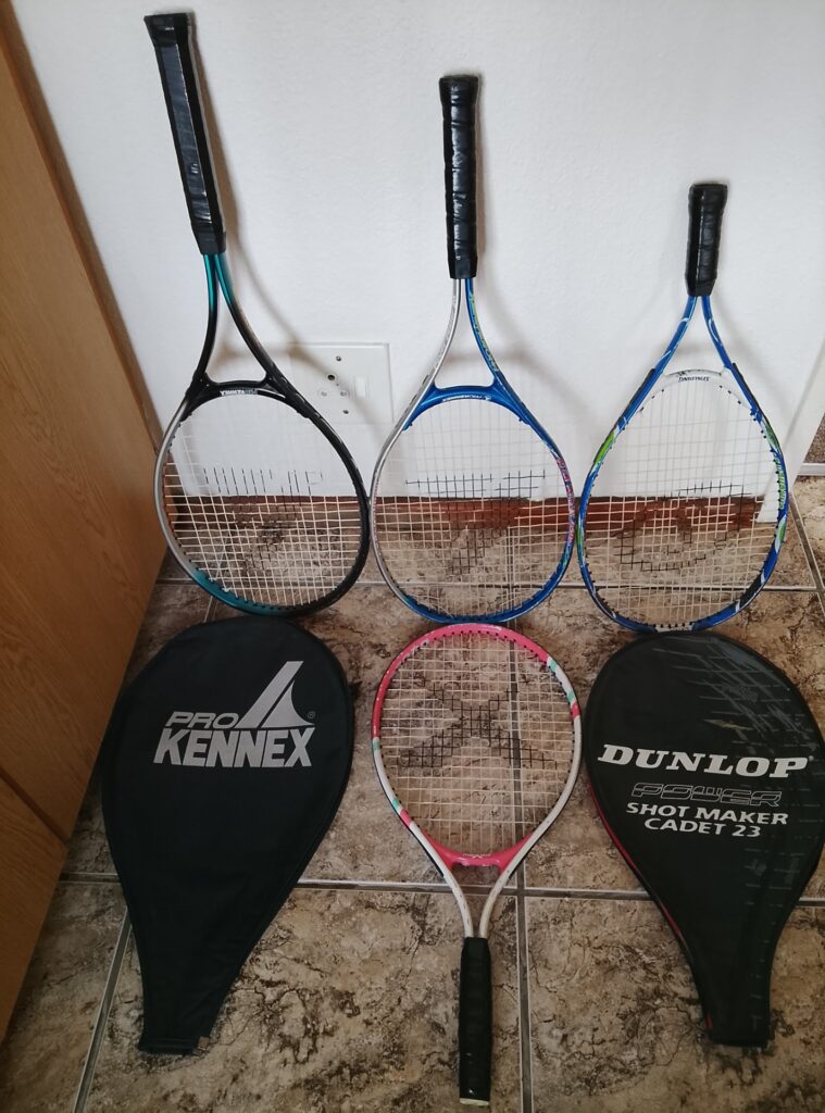 Lot of 4 used tennis rackets (ProKennex visible) with 2 soft covers — mixed condition, several broken strings