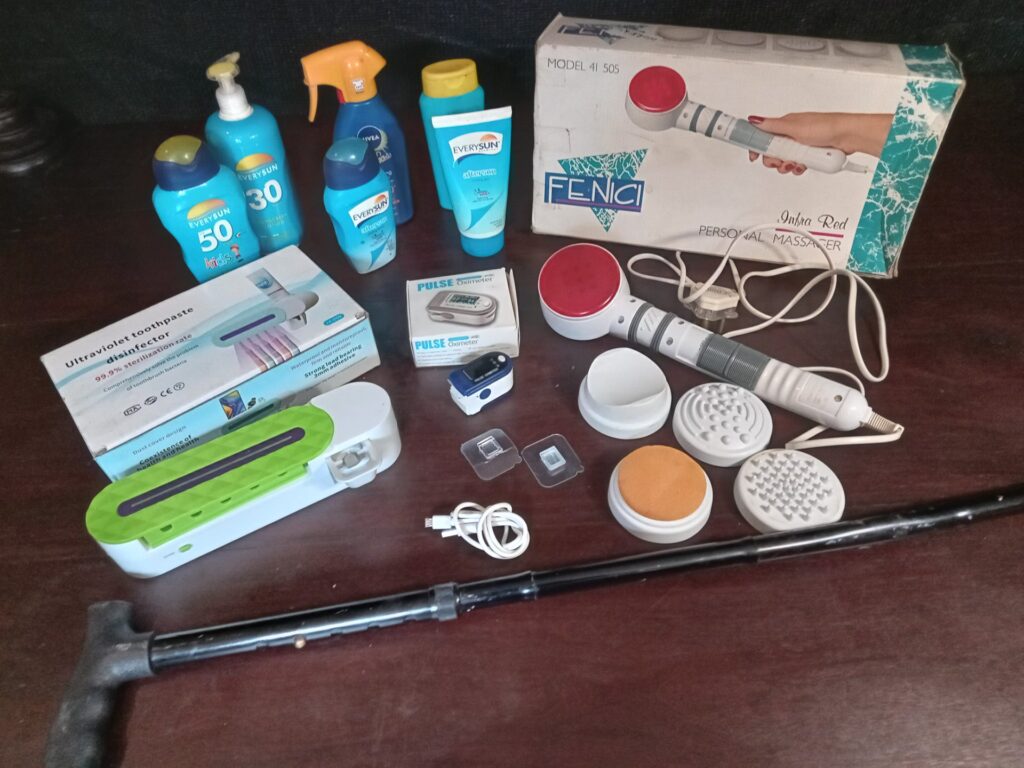 Mixed household personal-care lot — Fenici handheld massager + pulse oximeter + UV toothbrush steriliser + sunscreens & accessories (used, working)