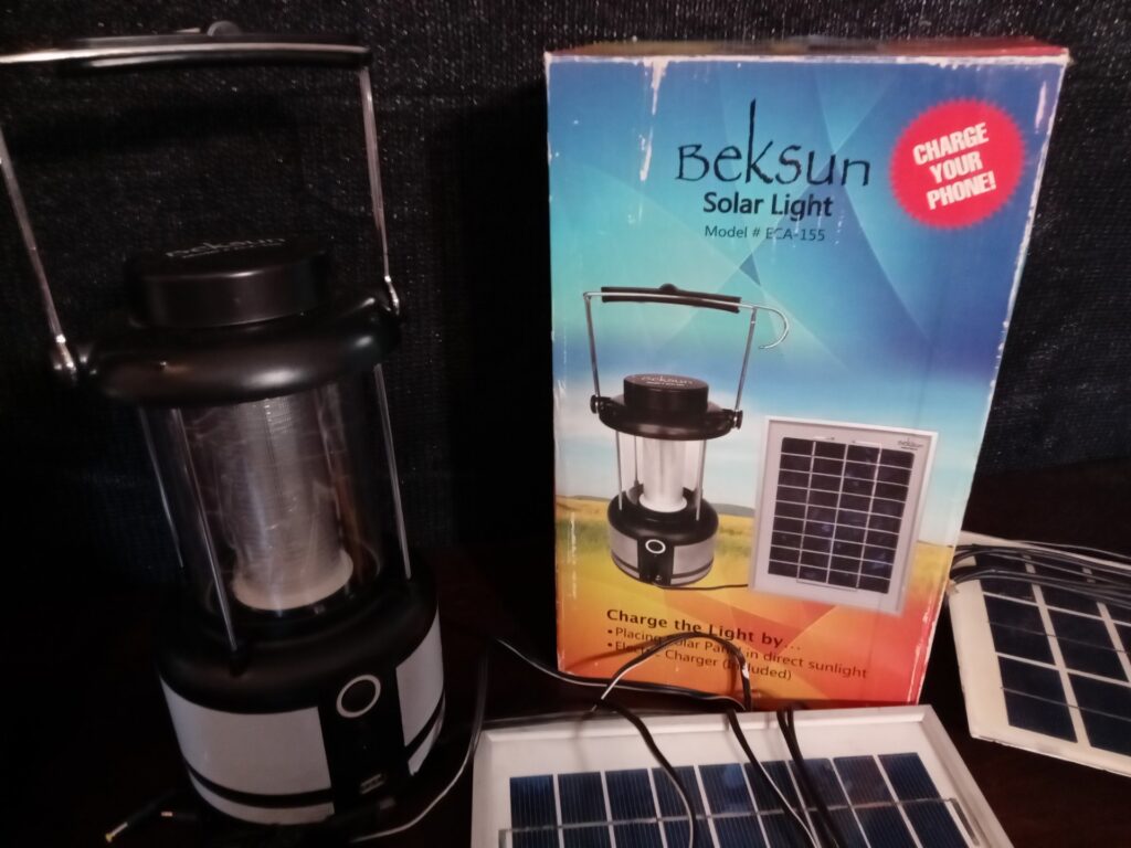 Mixed lot — 2 Beksun solar lanterns (one boxed), 2 small solar panels, LED string lights & assorted chargers (spares/repairs)