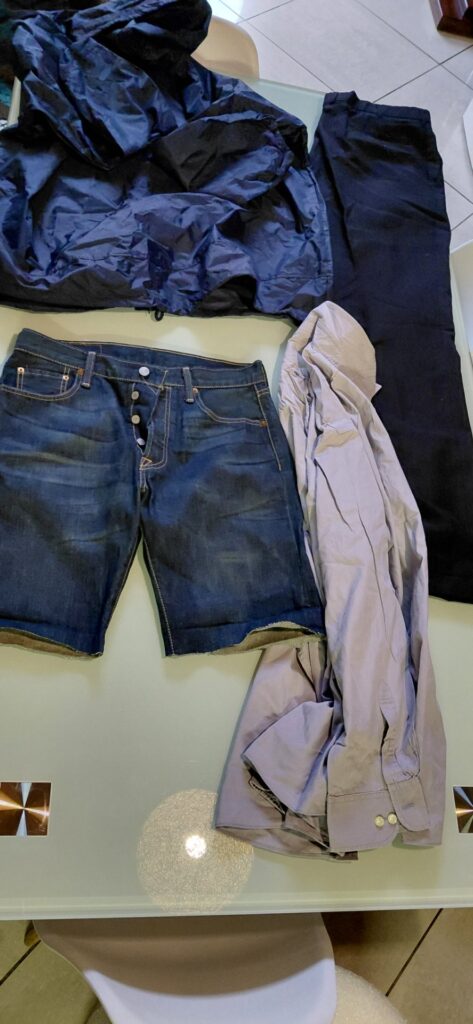 Lot 09 — Mixed Men’s Clothing: Navy Windbreaker (XL), Levi’s 501 W30 (cut to shorts), Formal Trousers & Light Purple Shirt