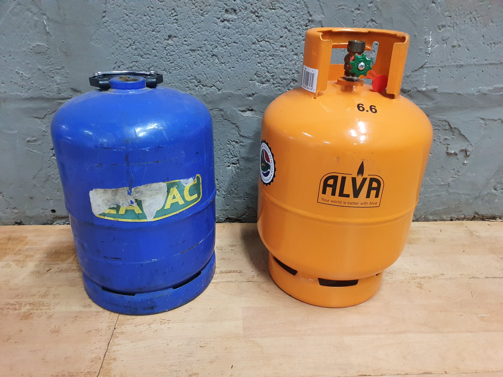 Pair of portable LPG cylinders — Orange ALVA (marked 6.6) + Blue CADAC — valves/adapters present, untested, partly full