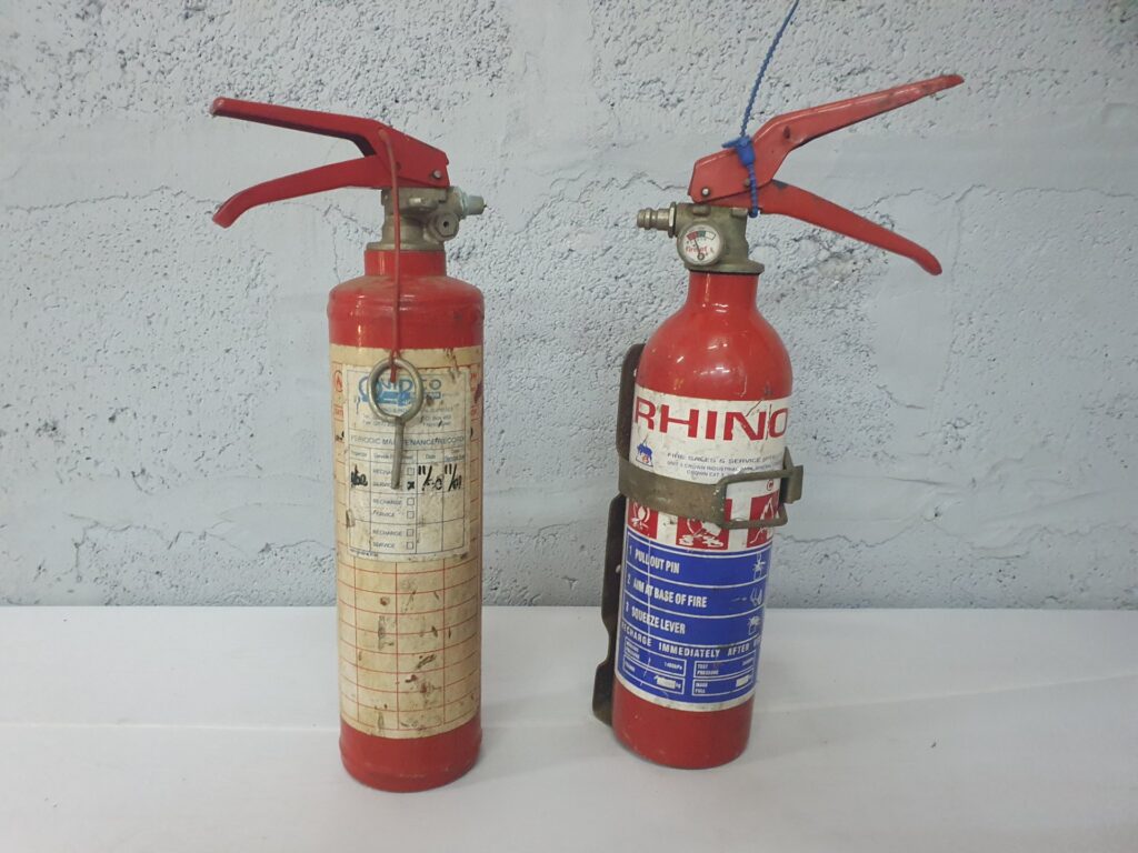 Lot of 2 portable fire extinguishers — one labelled RHINO; used, untested, needs refilling