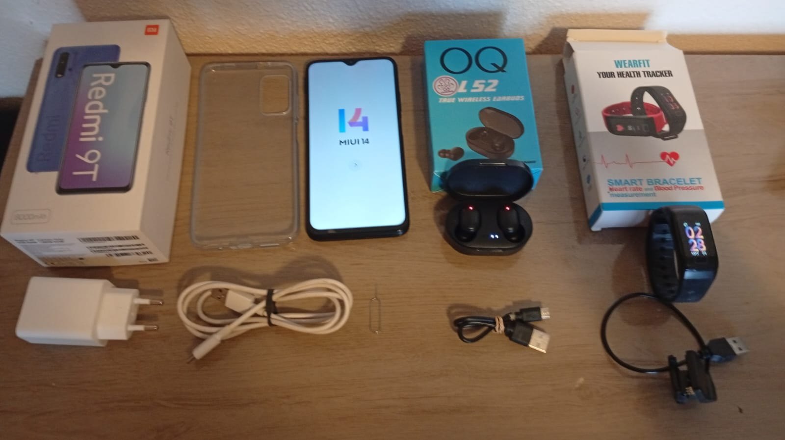 Xiaomi Redmi 9T smartphone lot — boots to MIUI + OOQ L52 earbuds & WearFit smart bracelet (boxes, chargers, case)
